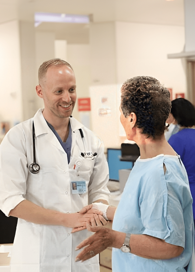 A cardiologist shaking a patients hand.